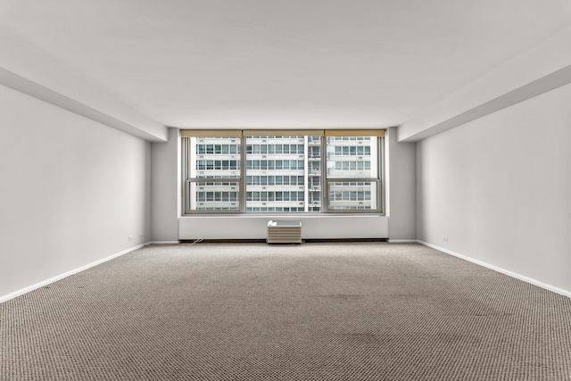 empty room featuring carpet flooring and baseboards