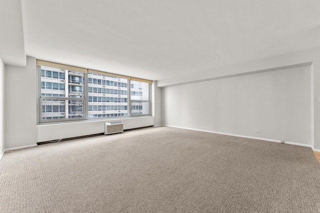 empty room with carpet and baseboards