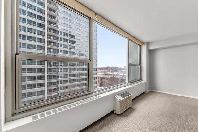 unfurnished room with a view of city, a wall mounted AC, carpet, and baseboards