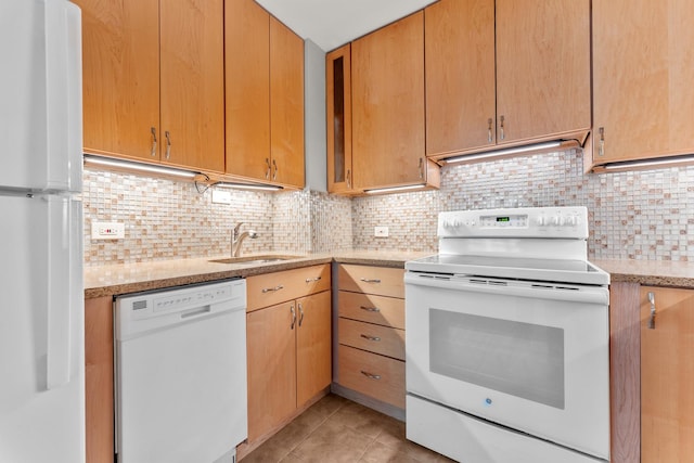 kitchen featuring light tile patterned floors, decorative backsplash, a sink, light stone countertops, and white appliances