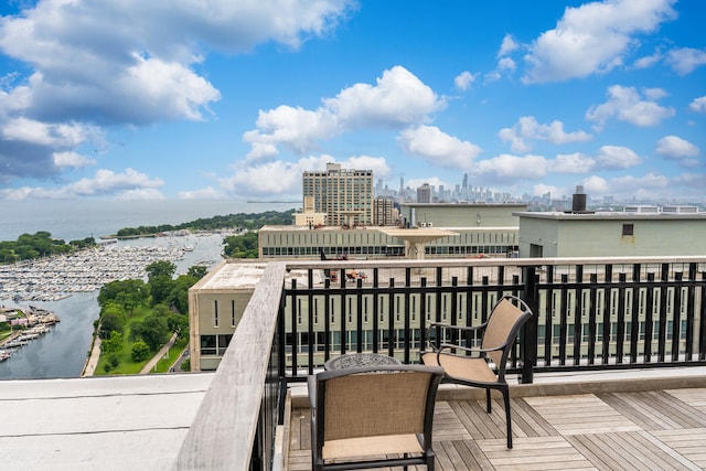 balcony with a water view and a city view