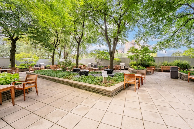 view of patio featuring a fenced backyard and a fire pit