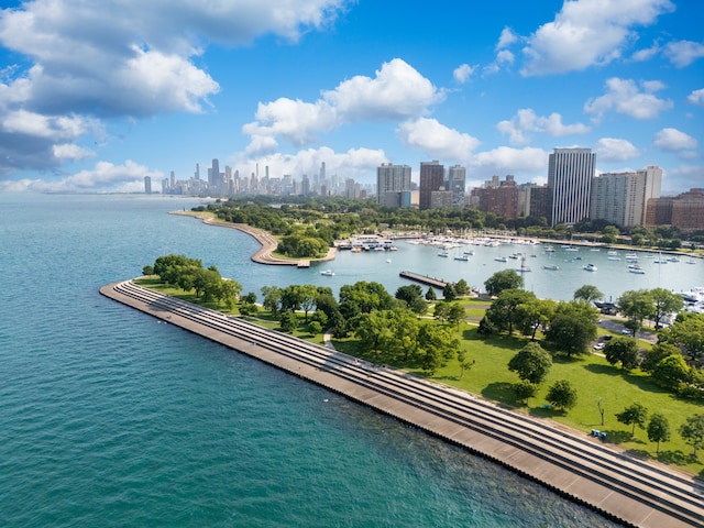 birds eye view of property with a city view and a water view