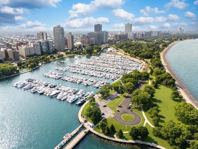 birds eye view of property with a view of city and a water view