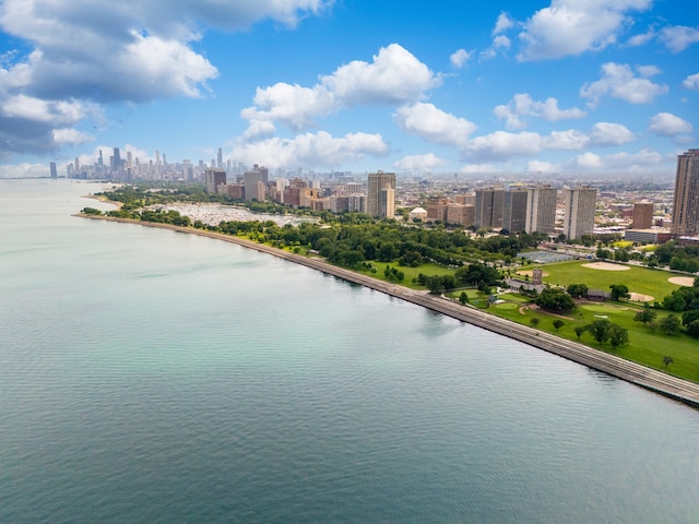 birds eye view of property featuring a view of city and a water view