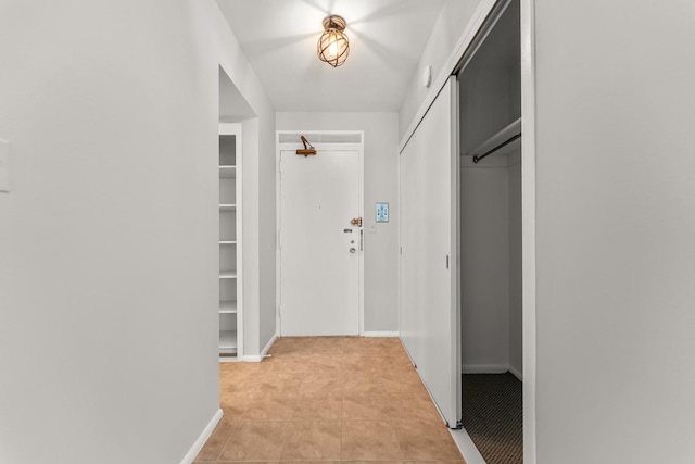 corridor featuring baseboards