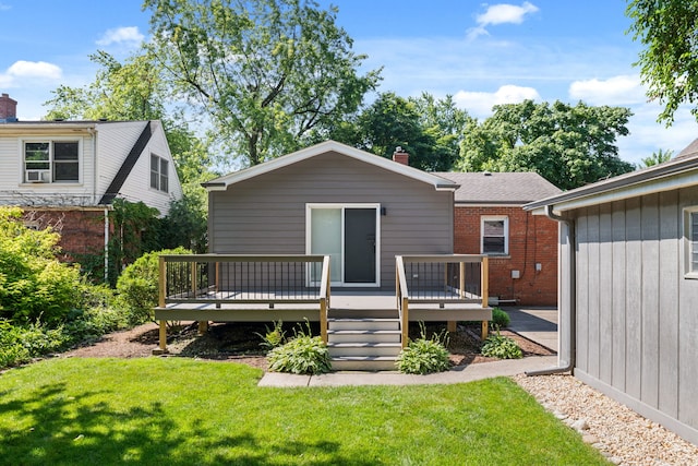 rear view of property featuring a yard and a deck