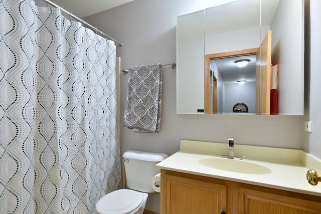 bathroom featuring toilet, a shower with curtain, and vanity