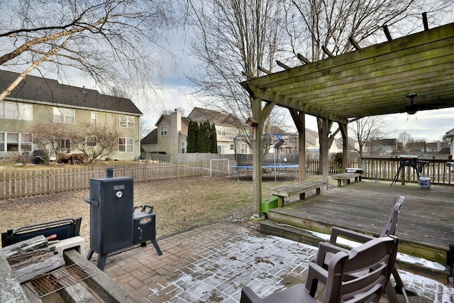 view of patio featuring a trampoline, a pergola, and a deck