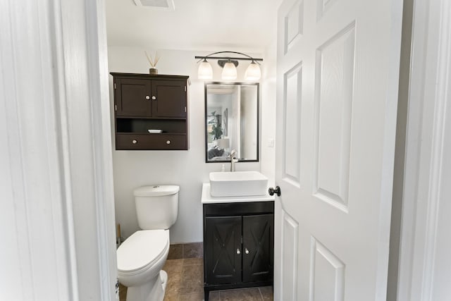 bathroom with visible vents, toilet, and vanity