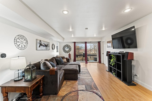 living room featuring recessed lighting, baseboards, and light wood finished floors