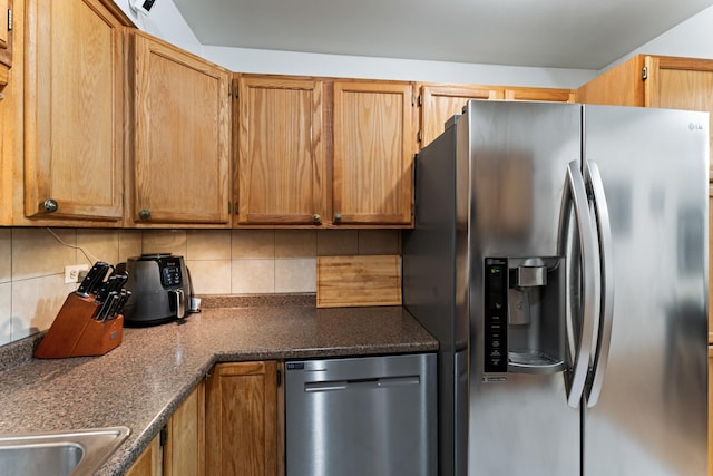kitchen featuring decorative backsplash, brown cabinets, and appliances with stainless steel finishes