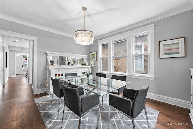 dining area featuring a notable chandelier, ornamental molding, and dark wood-type flooring