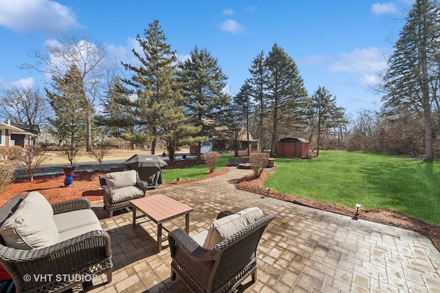 view of patio featuring an outbuilding, area for grilling, an outdoor living space, and a storage shed