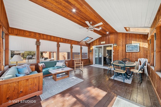 sunroom with lofted ceiling with skylight, wood ceiling, and a ceiling fan