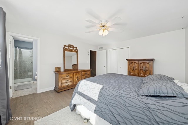 bedroom featuring a closet, visible vents, ceiling fan, wood finished floors, and baseboards