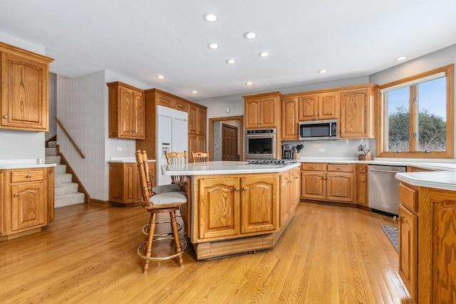 10848 Crystal Ridge Ct, Orland Park, IL 60467 - kitchen featuring light wood-style flooring, recessed lighting, a kitchen island, appliances with stainless steel finishes, and light countertops