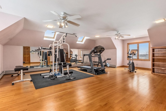 10848 Crystal Ridge Ct, Orland Park, IL 60467 - workout area featuring light wood-type flooring, vaulted ceiling with skylight, and a ceiling fan