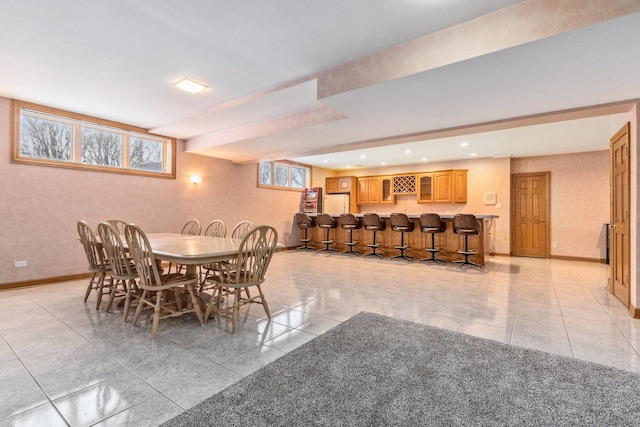 dining room featuring light tile patterned flooring and bar