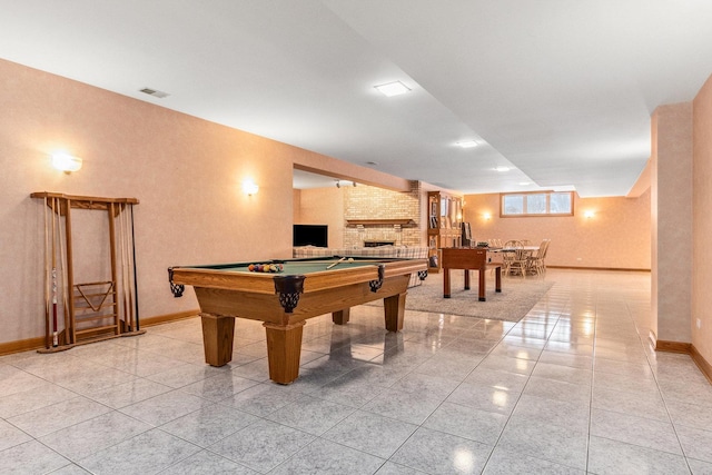 recreation room with a fireplace, pool table, and light tile patterned floors