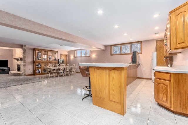 10848 Crystal Ridge Ct, Orland Park, IL 60467 - kitchen with baseboards, open floor plan, light countertops, a kitchen breakfast bar, and a peninsula