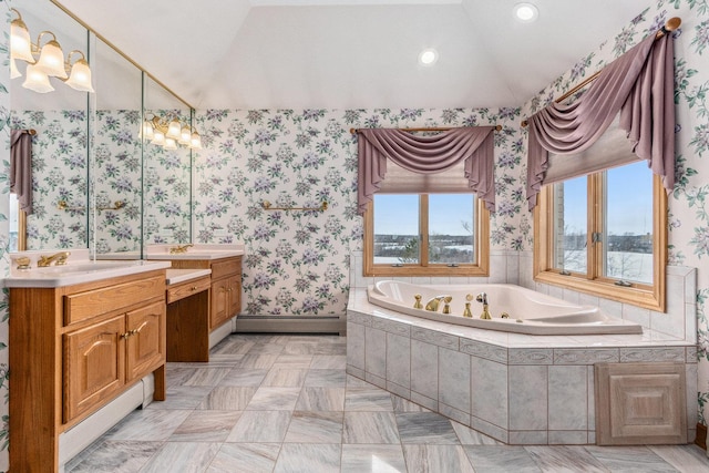 bathroom featuring baseboard heating, lofted ceiling, vanity, and tiled tub