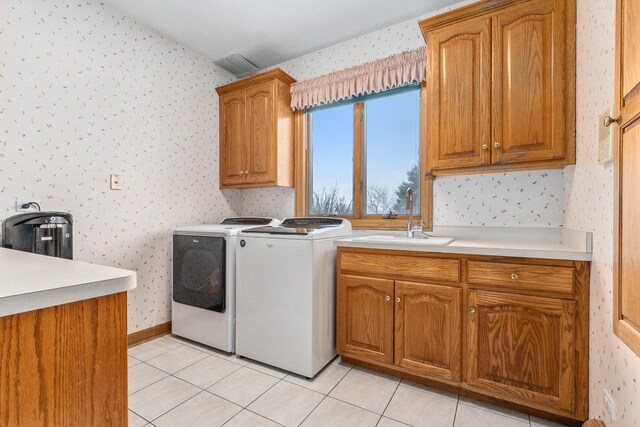 10848 Crystal Ridge Ct, Orland Park, IL 60467 - laundry room with wallpapered walls, light tile patterned floors, cabinet space, washer and dryer, and a sink