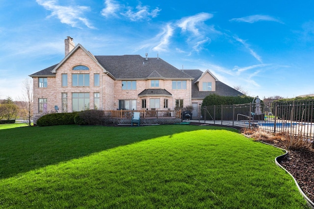 10848 Crystal Ridge Ct, Orland Park, IL 60467 - rear view of house featuring brick siding, a chimney, fence, and a lawn