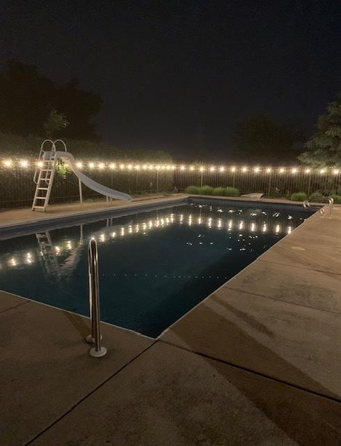 view of pool at night