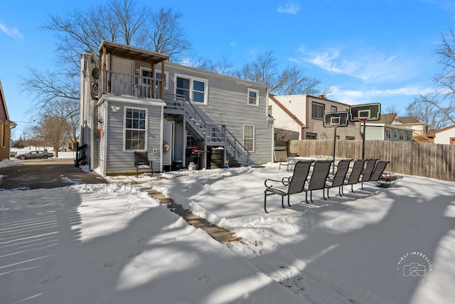 snow covered house with a balcony