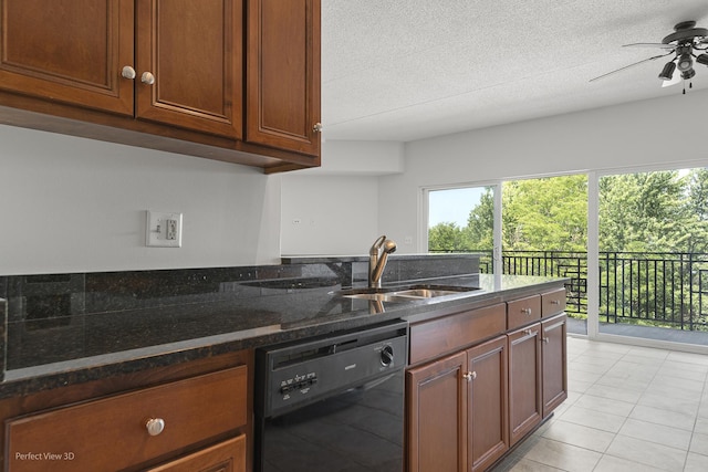 kitchen featuring sink, a textured ceiling, ceiling fan, dishwasher, and dark stone counters