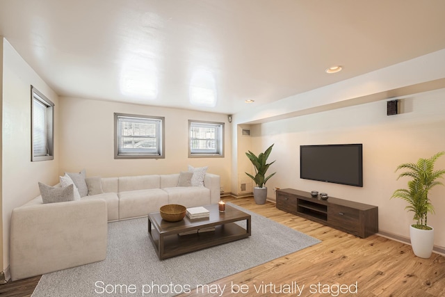living area featuring baseboards, recessed lighting, and wood finished floors