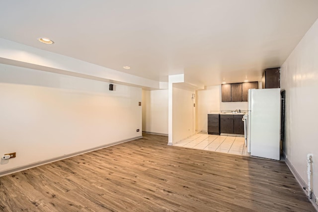 unfurnished living room with visible vents, baseboards, recessed lighting, and light wood-style floors