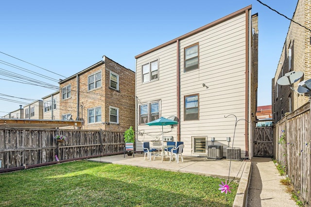 back of property featuring a patio, central air condition unit, a fenced backyard, and a yard