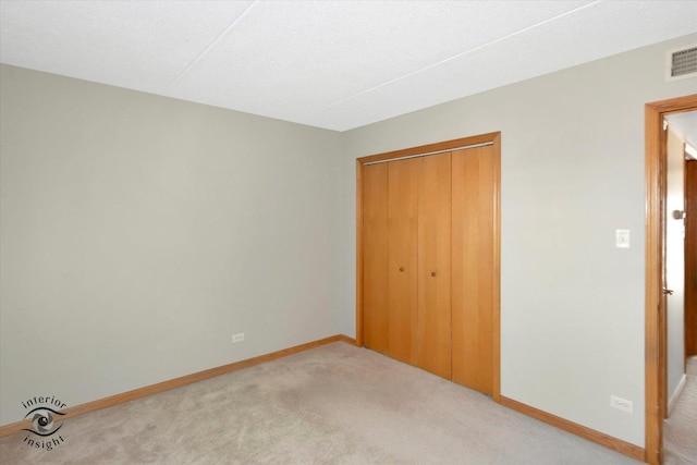 8136 168th Pl Unit 2W, Tinley Park, IL 60477 - unfurnished bedroom featuring light colored carpet, a closet, and baseboards