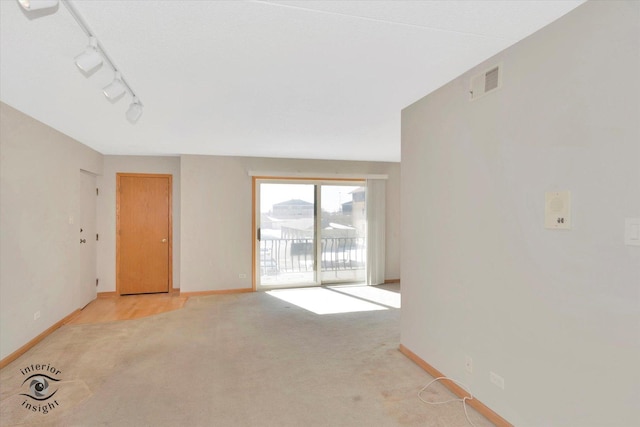 empty room with light carpet, baseboards, and visible vents