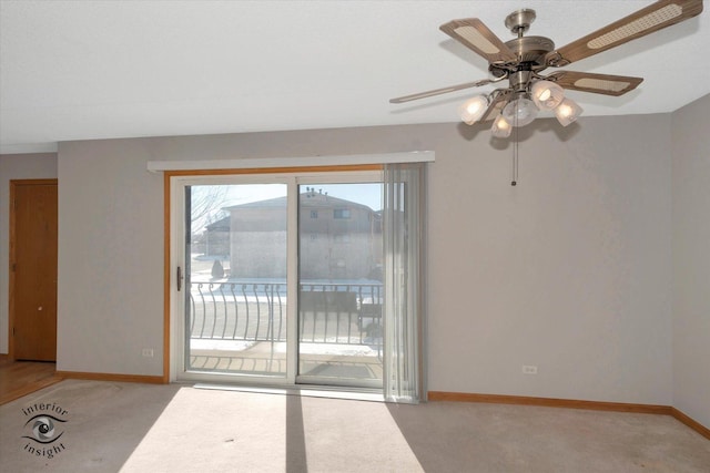 unfurnished room featuring light colored carpet, ceiling fan, and baseboards