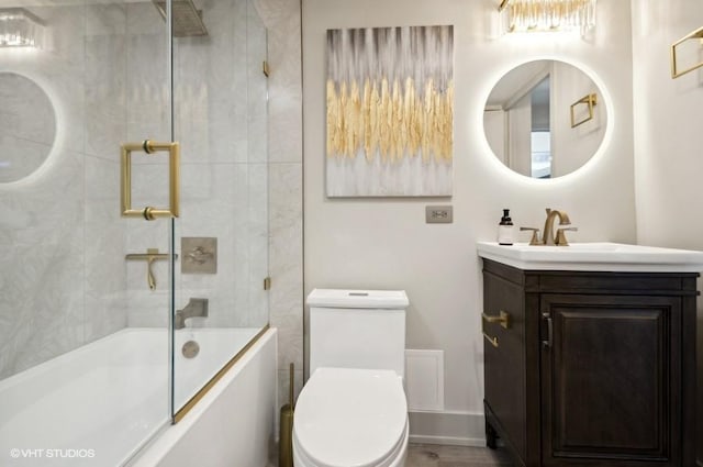 full bathroom featuring toilet, vanity, and combined bath / shower with glass door