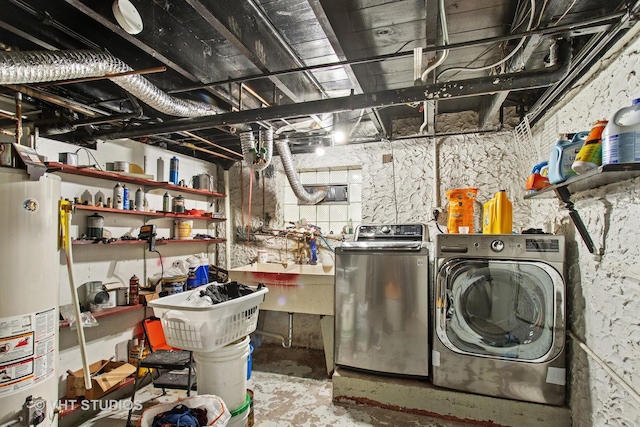 washroom featuring laundry area, separate washer and dryer, gas water heater, and a sink