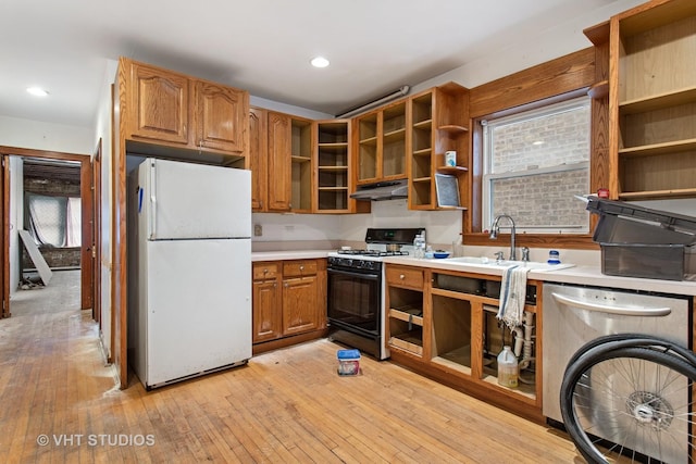 kitchen with freestanding refrigerator, under cabinet range hood, open shelves, stainless steel dishwasher, and gas stove