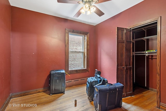 interior space featuring light wood-type flooring, ceiling fan, and baseboards