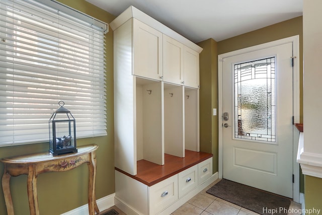 mudroom with light tile patterned floors and baseboards