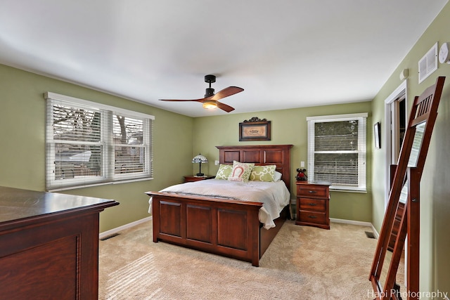 bedroom with light carpet, visible vents, and baseboards