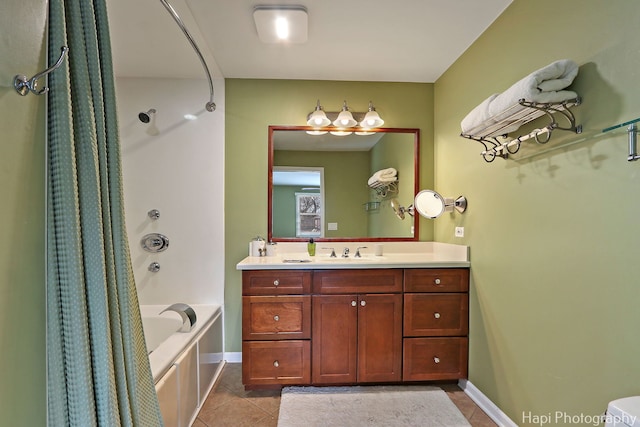 bathroom featuring tile patterned flooring, shower / tub combo with curtain, vanity, and baseboards