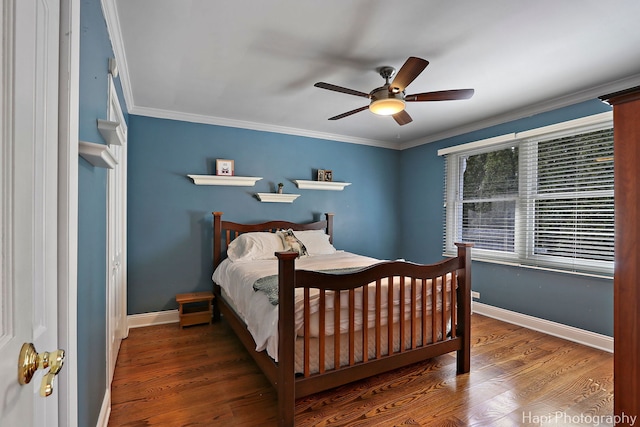 bedroom with crown molding, baseboards, and wood finished floors