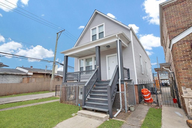 view of front of home with covered porch and a front lawn