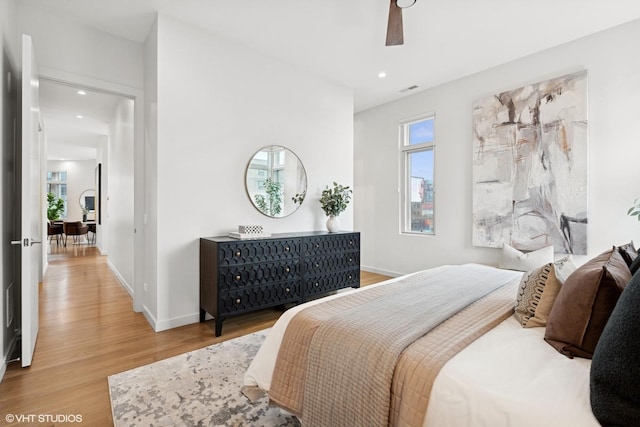 bedroom with visible vents, baseboards, wood finished floors, and recessed lighting