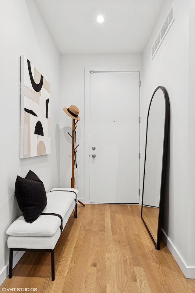 foyer entrance featuring light wood-type flooring, baseboards, visible vents, and recessed lighting