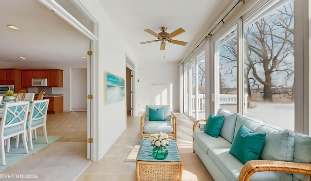 sunroom / solarium with a ceiling fan