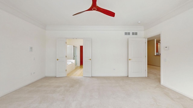 unfurnished bedroom featuring visible vents, ornamental molding, a ceiling fan, and light colored carpet